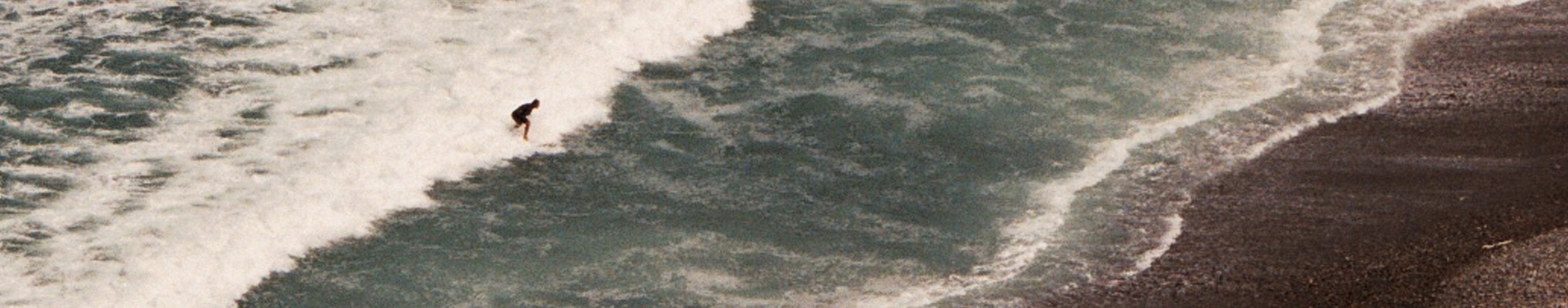 a surfer rides the ocean waves